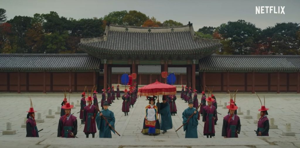 Queen Standing in Front of the Palace in Kingdom on Netflix